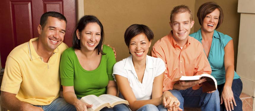 a family reviewing books while smiling